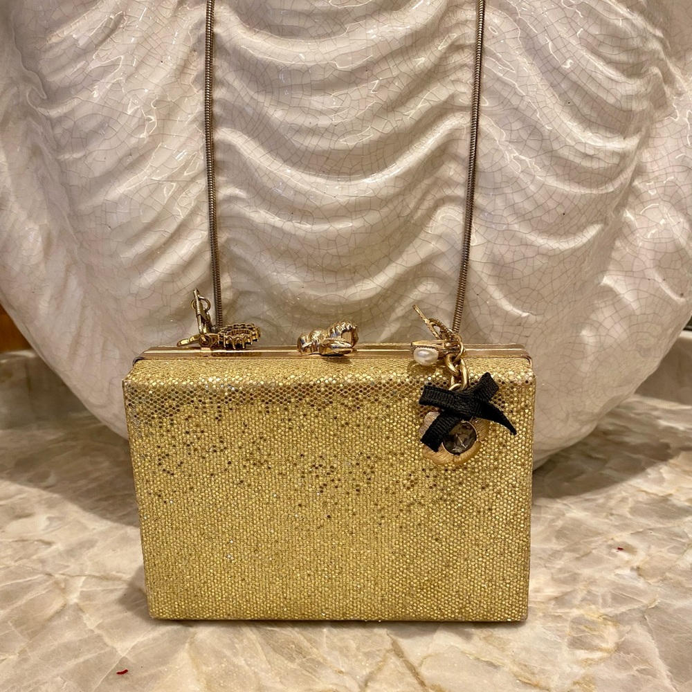 Gold evening bag with charms.